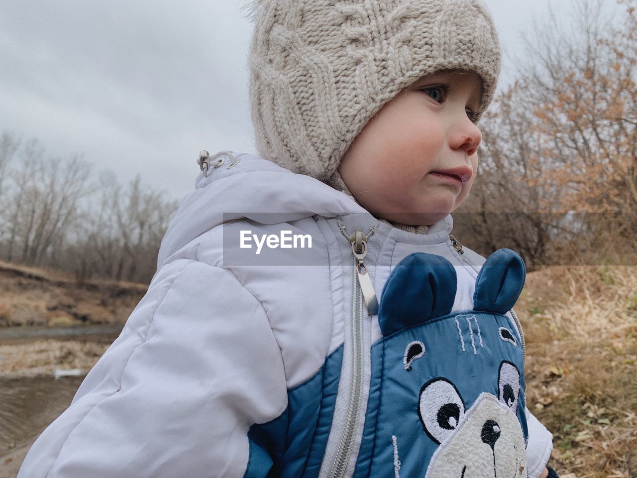 childhood, child, clothing, one person, winter, warm clothing, hat, toddler, cold temperature, nature, portrait, knit hat, baby, spring, men, day, innocence, glove, looking, cute, blue, snow, looking away, leisure activity, headshot, outdoors, sky, land, waist up, mitten