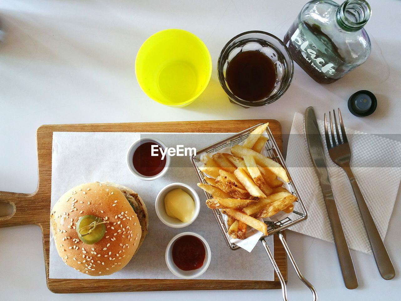 High angle view of burger on cutting board over table