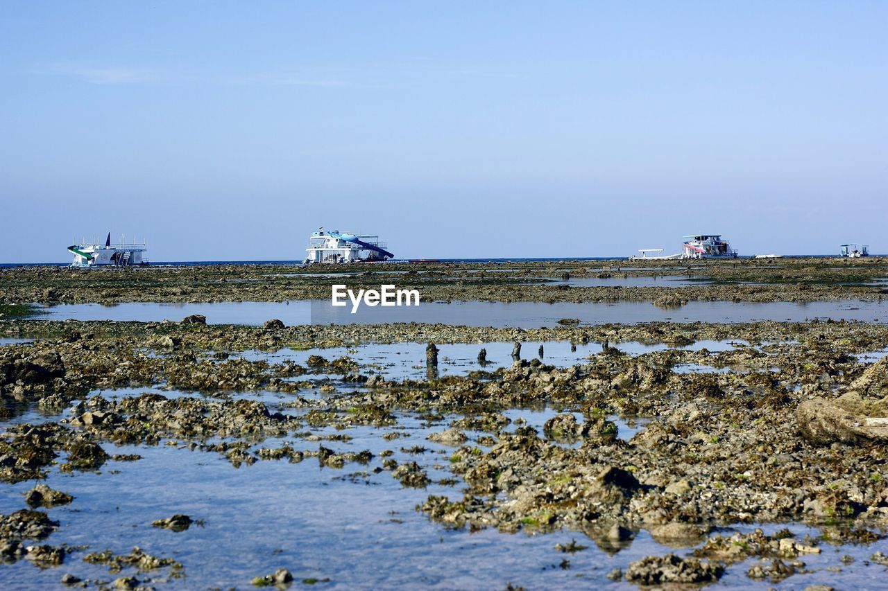 SCENIC VIEW OF LAND AGAINST SEA