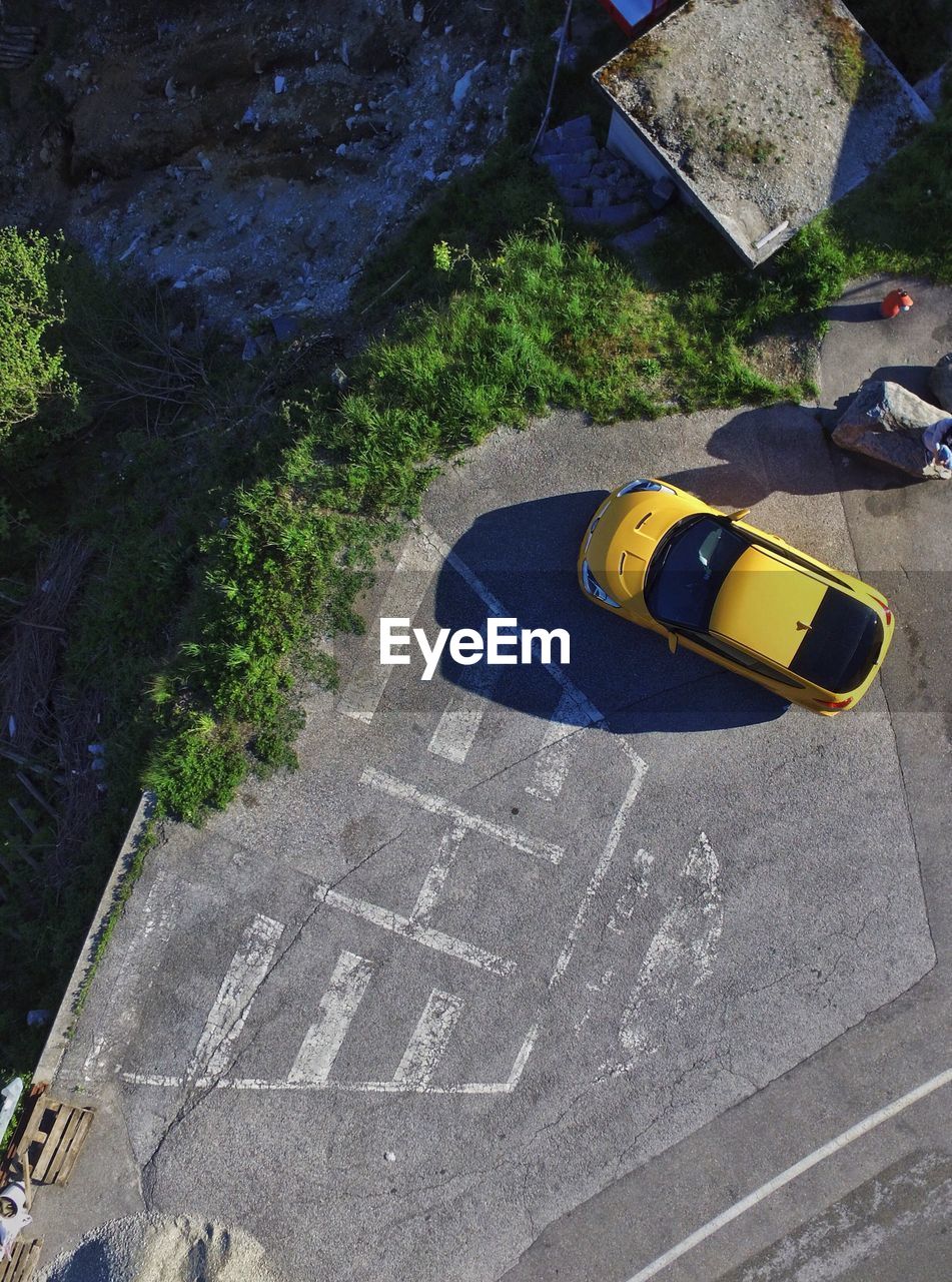 High angle view of yellow car on road