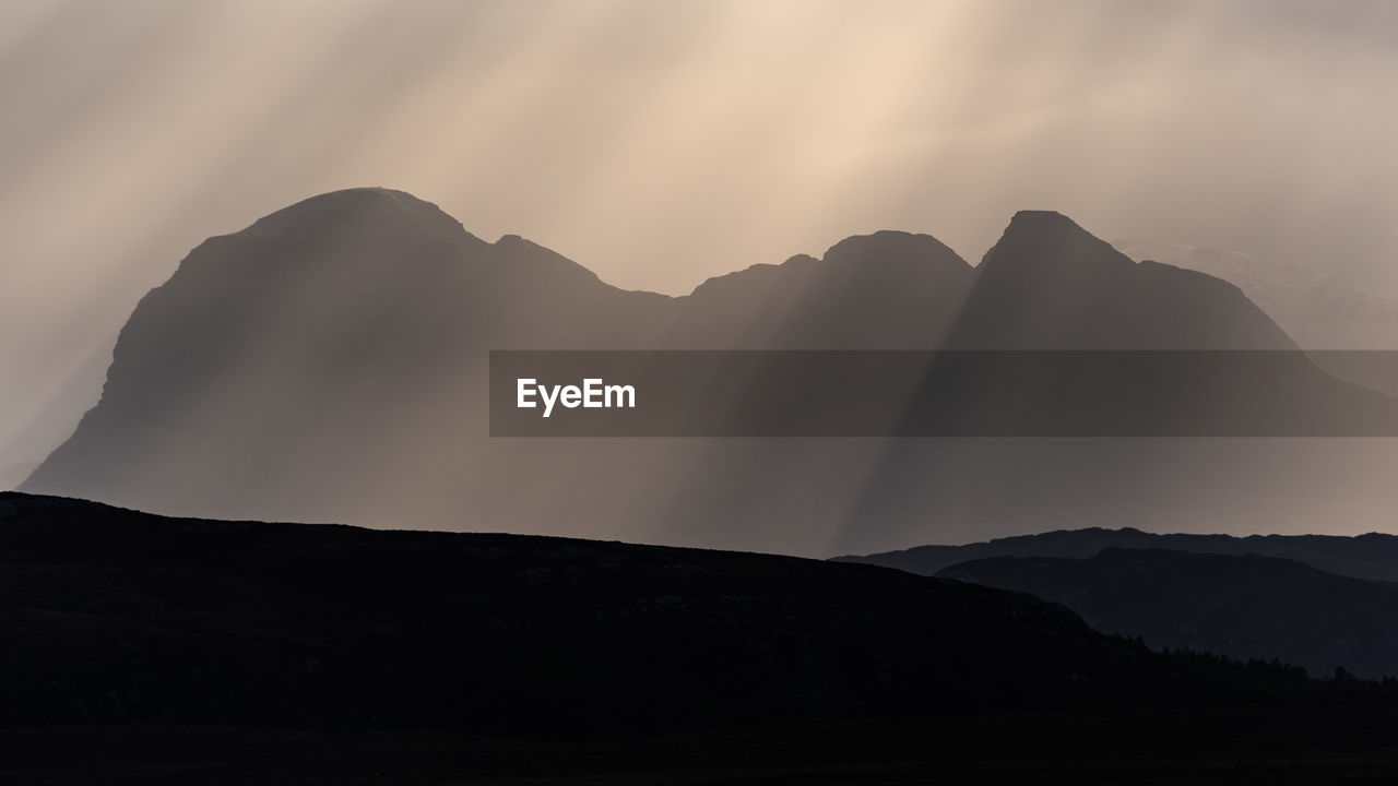 SILHOUETTE OF MOUNTAIN RANGE AGAINST SKY