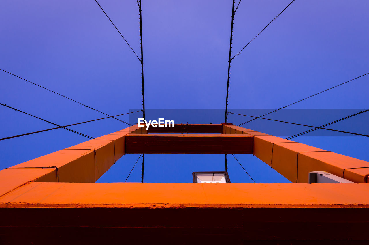 Low angle view of golden gate bridge against clear blue sky
