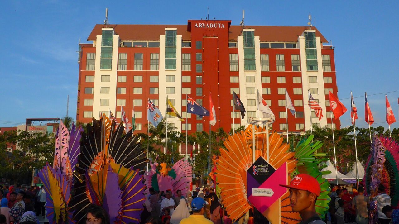 COLORFUL FLAGS AGAINST BLUE SKY