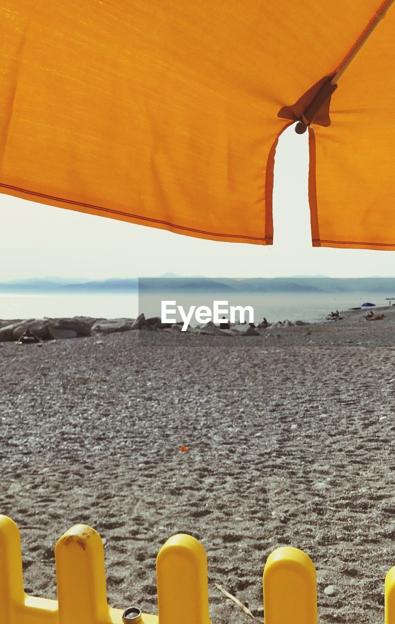 CLOSE-UP OF BEACH AGAINST SKY