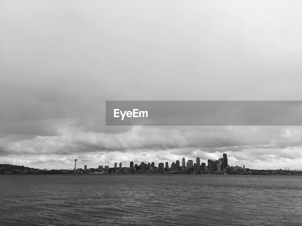 View of cityscape against cloudy sky