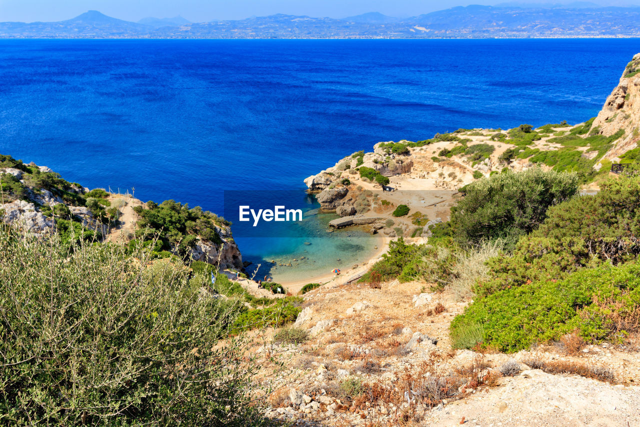A beautiful view from a steep rocky slope on the corinthian gulf and the blue lagoon on the coast.