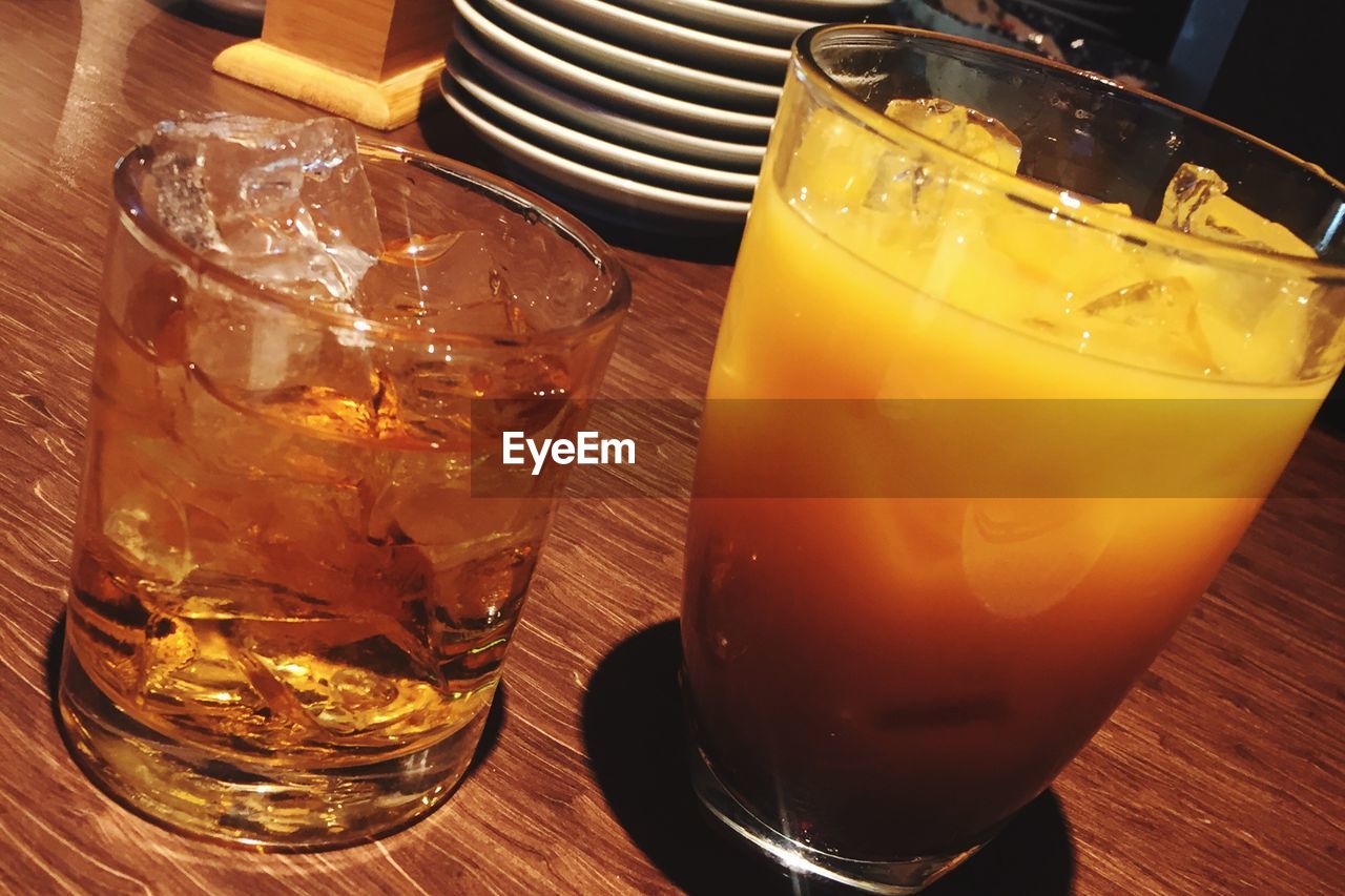 CLOSE-UP OF BEER GLASS ON TABLE