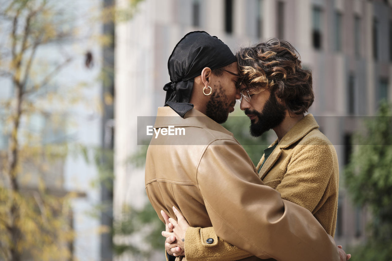 Couple embracing in front of building