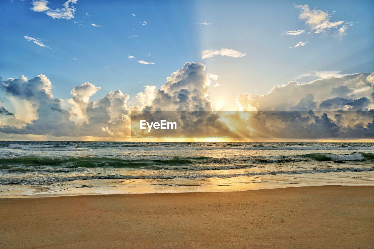 Scenic view of beach against sky during sunset