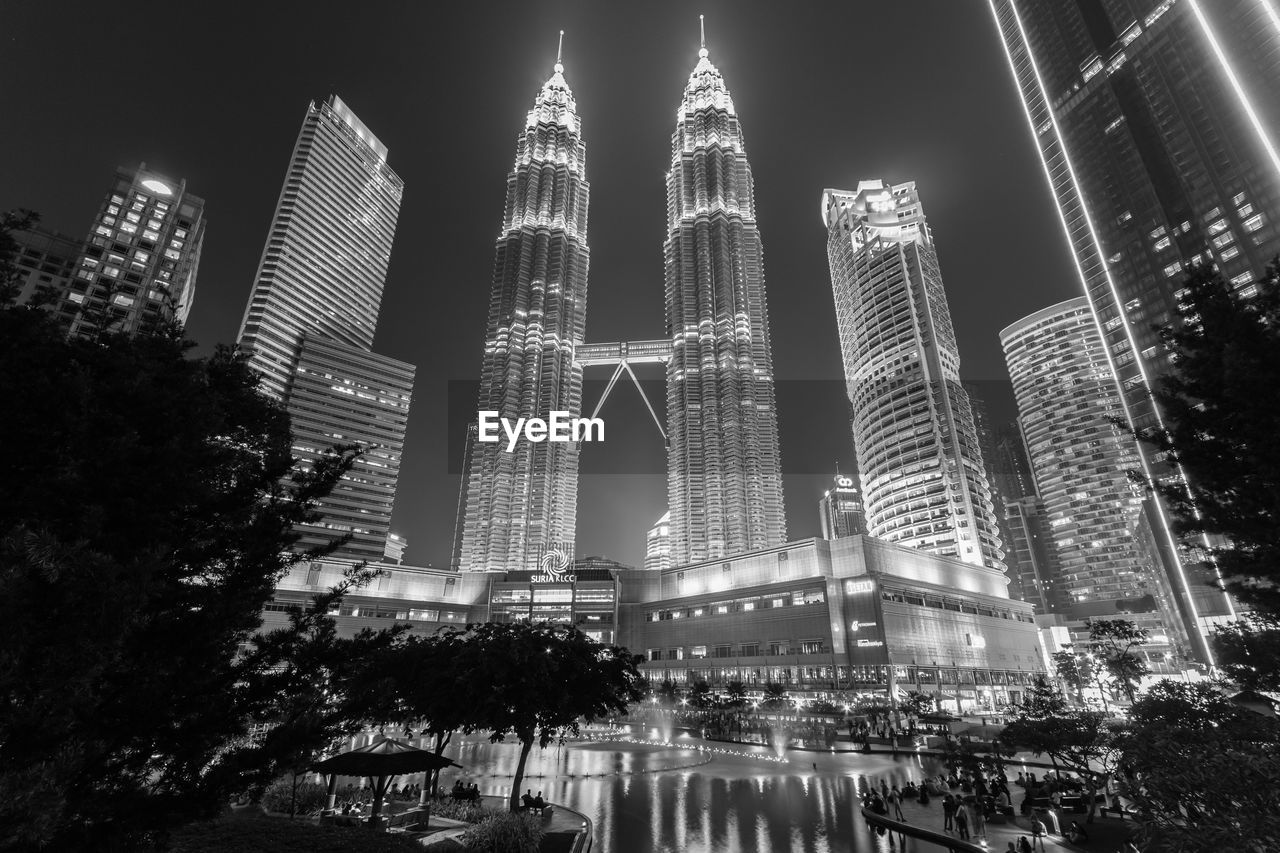 LOW ANGLE VIEW OF ILLUMINATED BUILDINGS AGAINST SKY