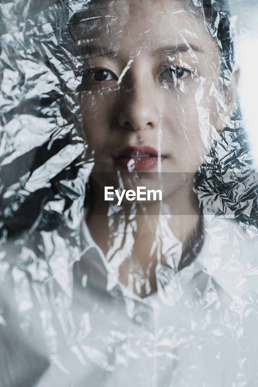 CLOSE-UP PORTRAIT OF WOMAN WITH SNOW ON WET HUMAN FACE