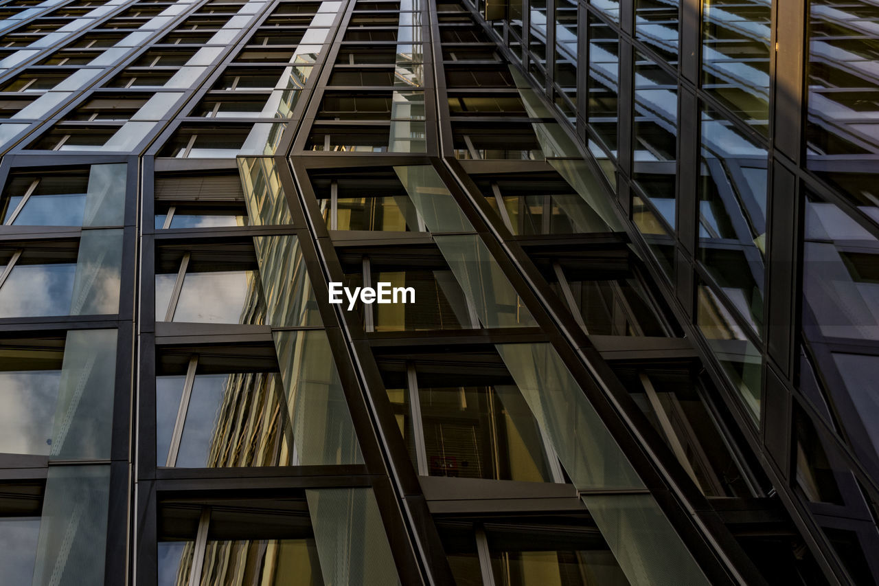 LOW ANGLE VIEW OF BUILDING WITH WINDOWS