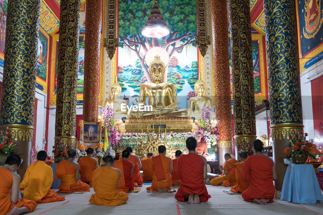 Buddhist monks inside temple for evening prayers