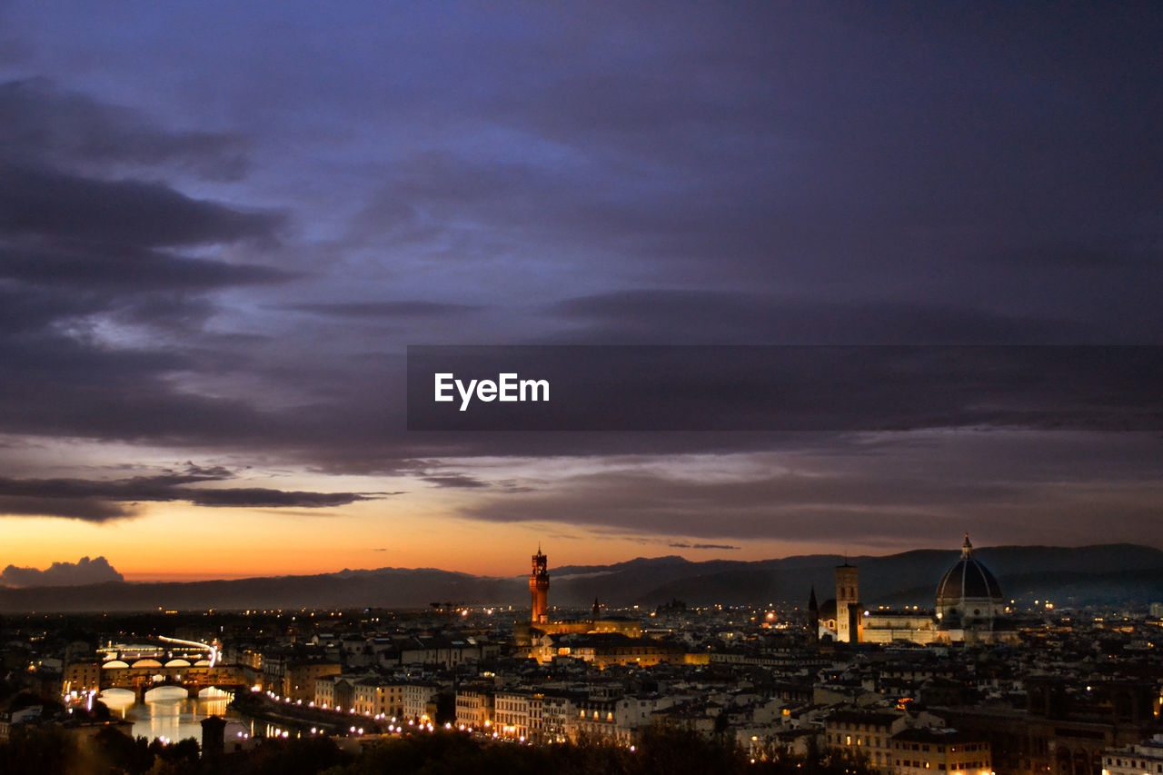 High angle view of illuminated buildings against sky at sunset