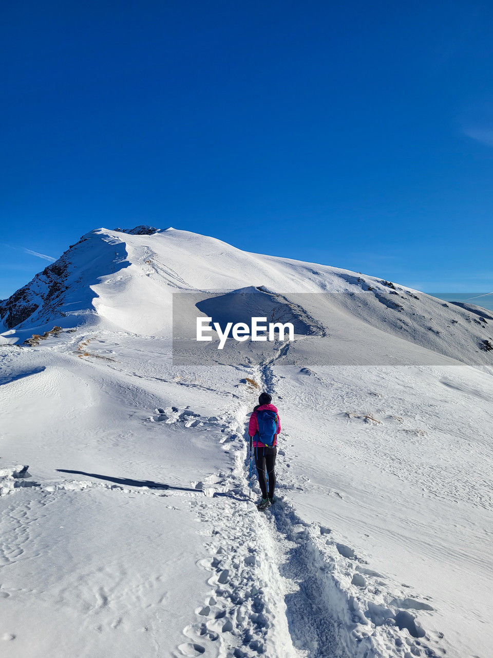 rear view of man skiing on snow covered mountain