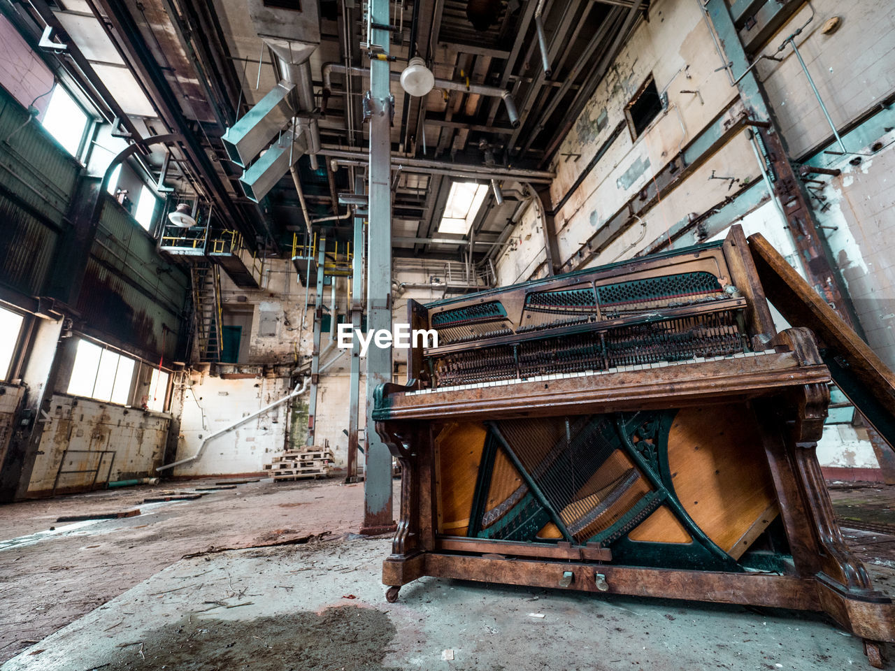 Weathered old piano in abandoned factory