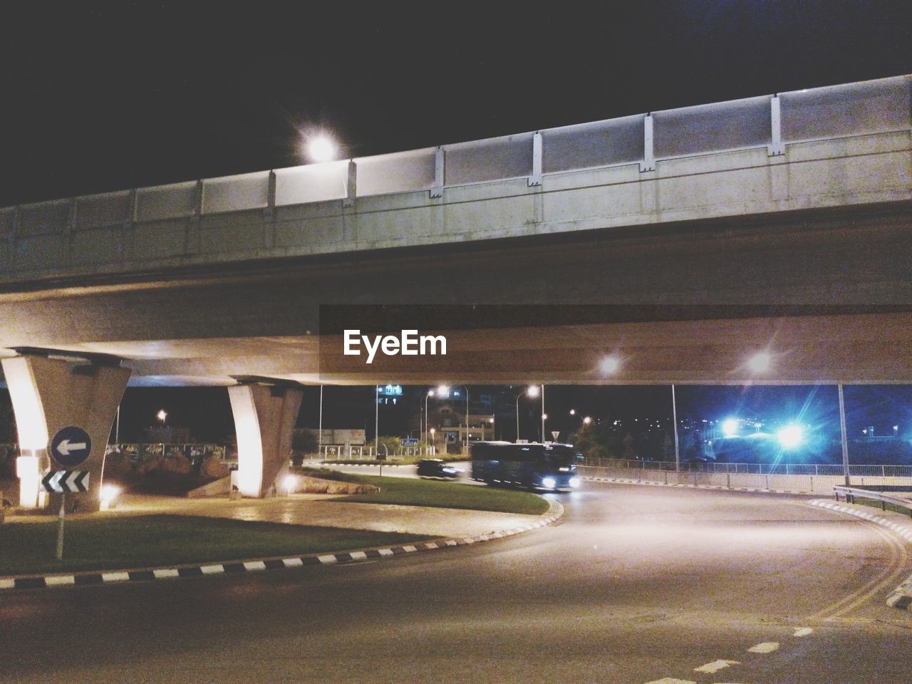 Illuminated bridge in city at night