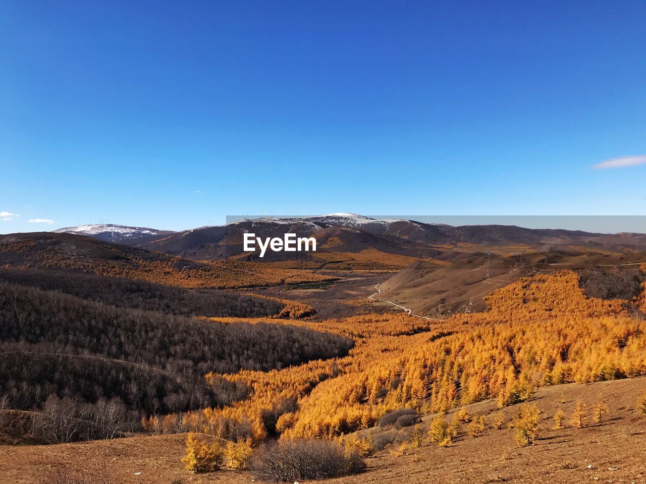 Scenic view of mountains against clear blue sky