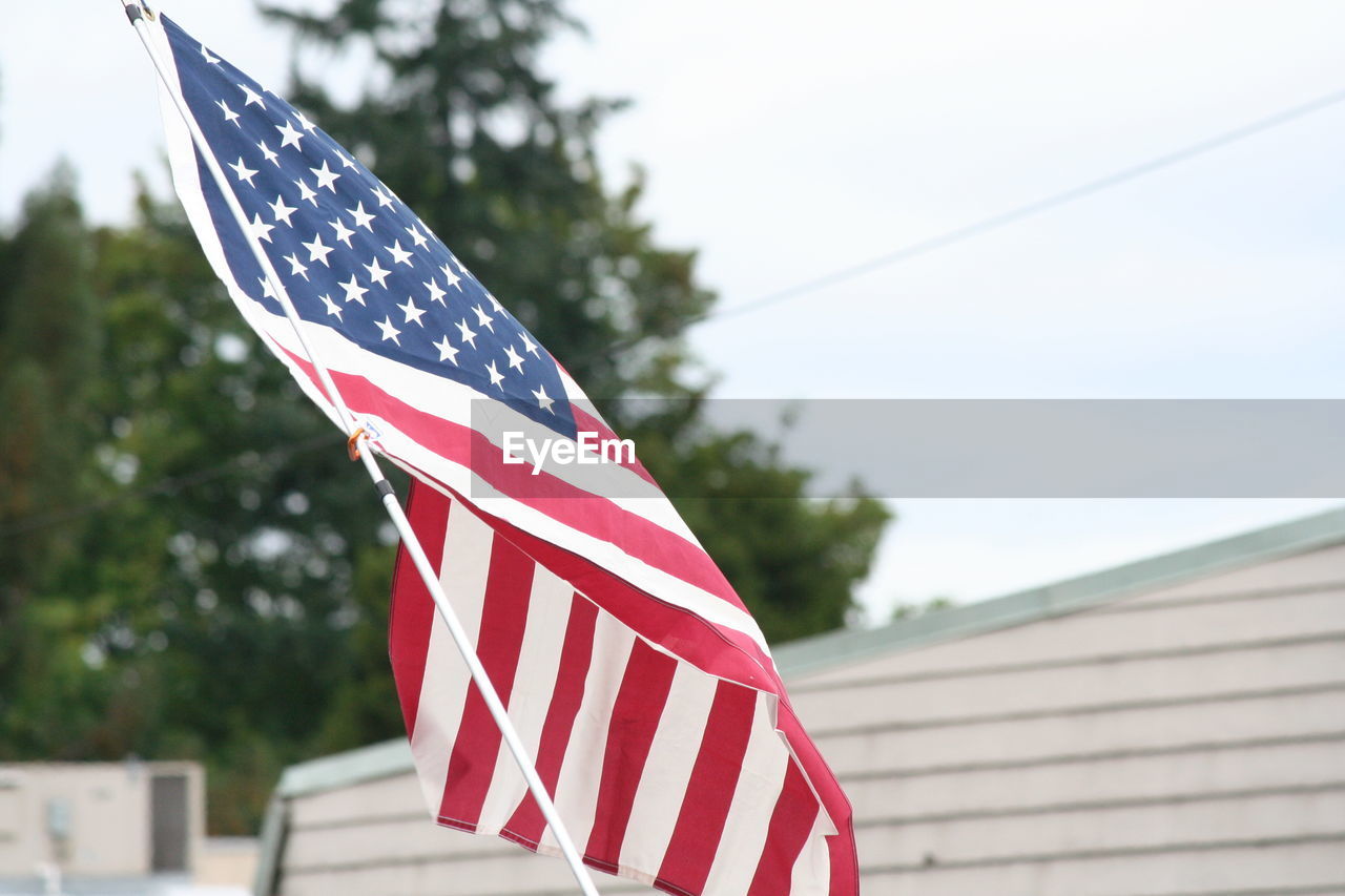 American flag against sky on fourth of july parade