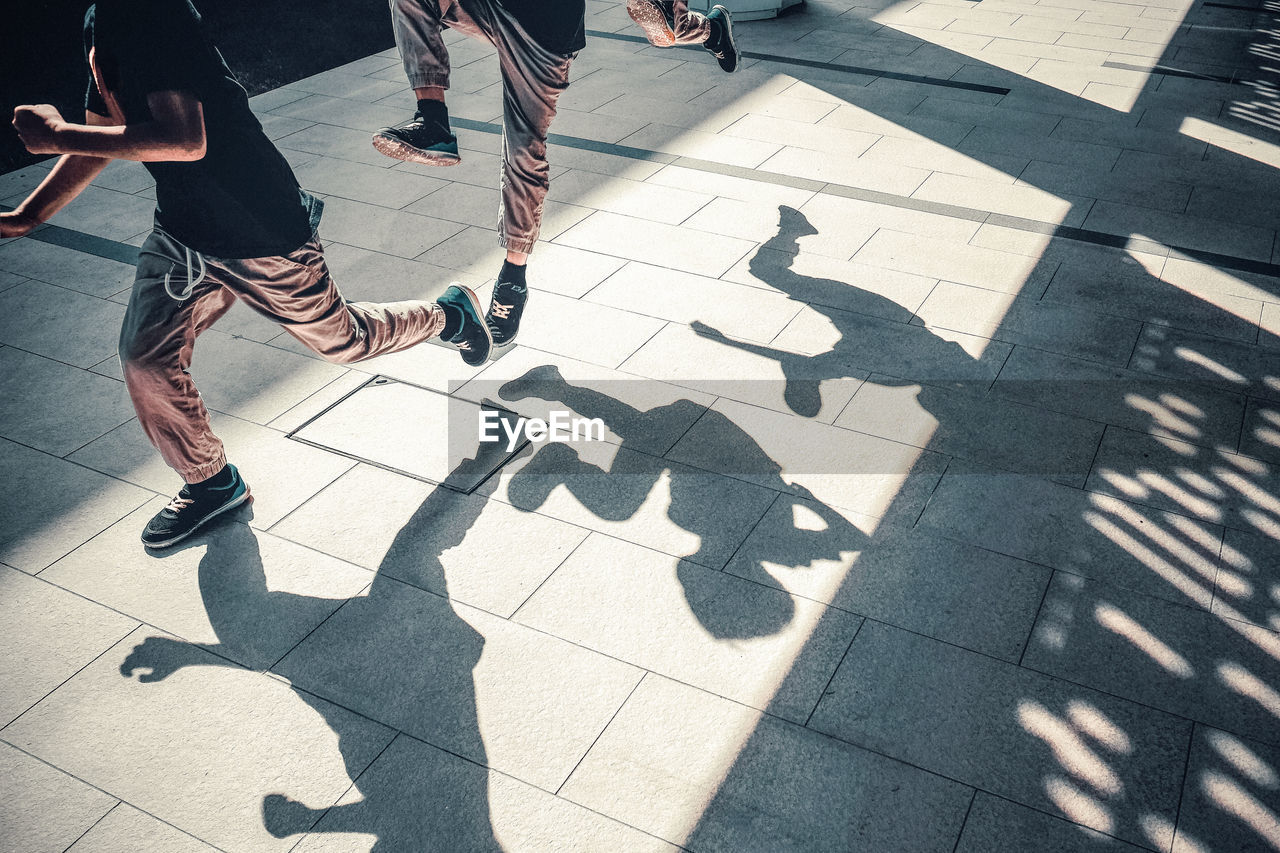 Multiple image of boy running on footpath