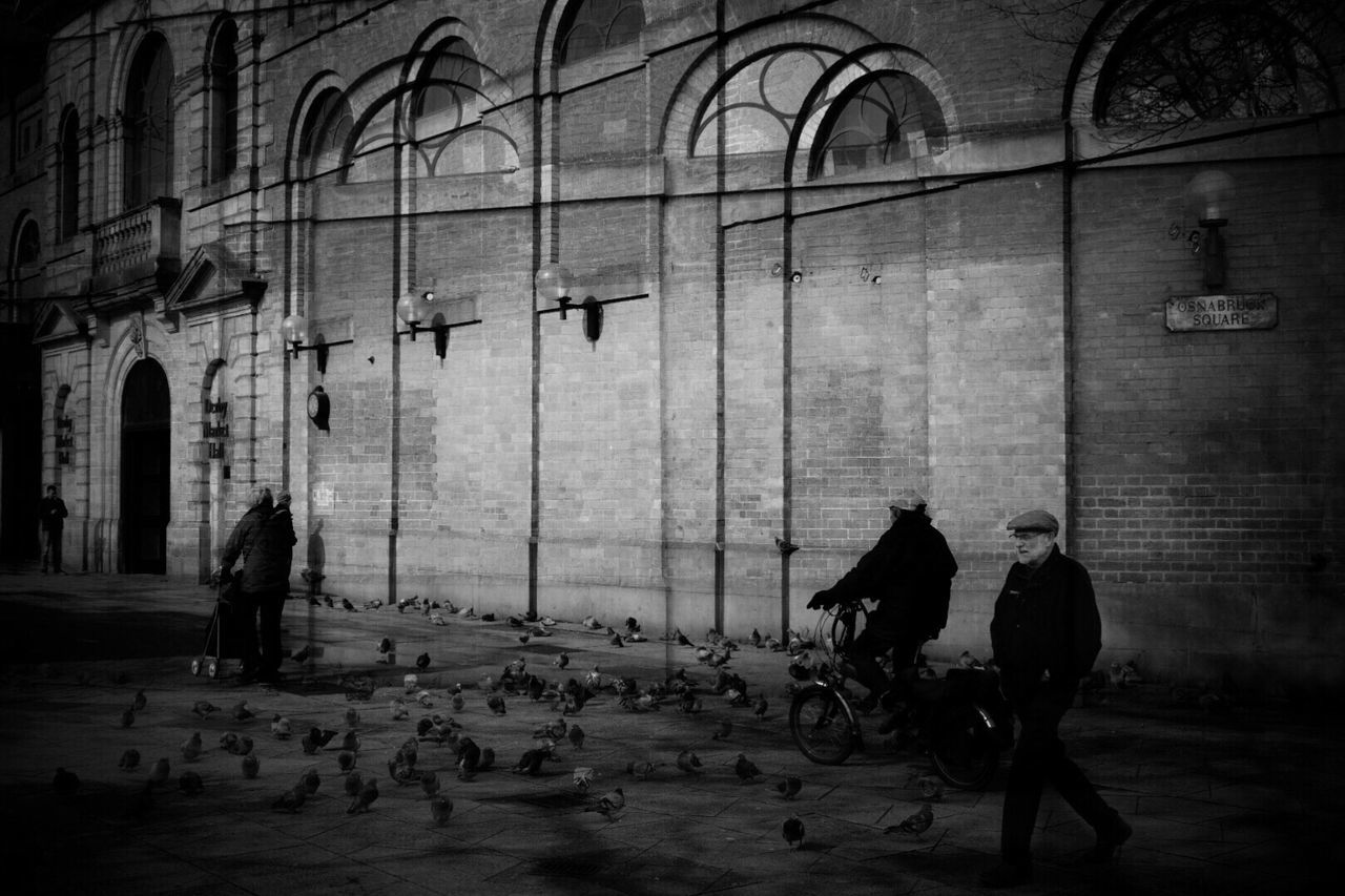 PEOPLE SITTING ON WALL