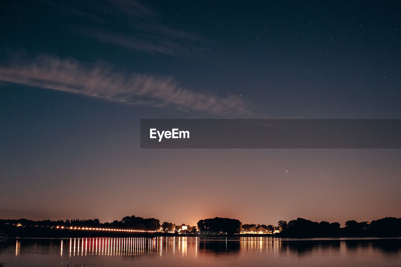 VIEW OF LAKE AGAINST SKY AT NIGHT