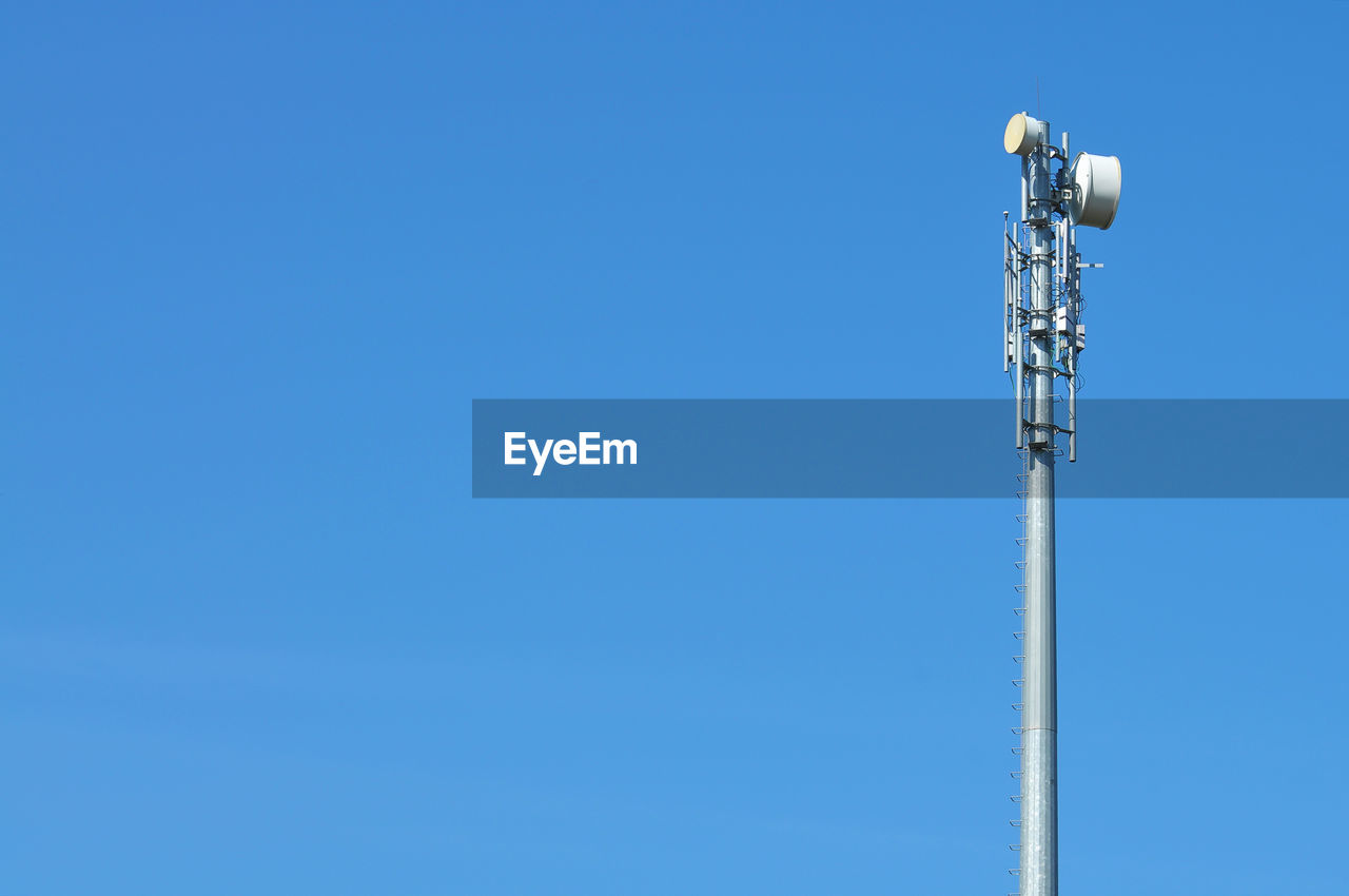 Low angle view of communications tower against sky