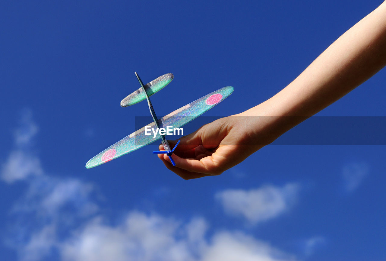 Hand of a child holding model airplane