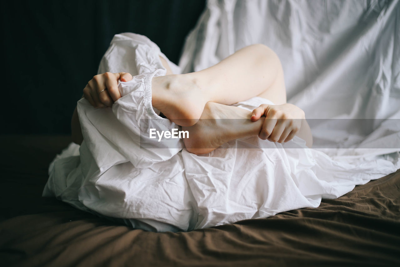 Close-up woman holding her feet