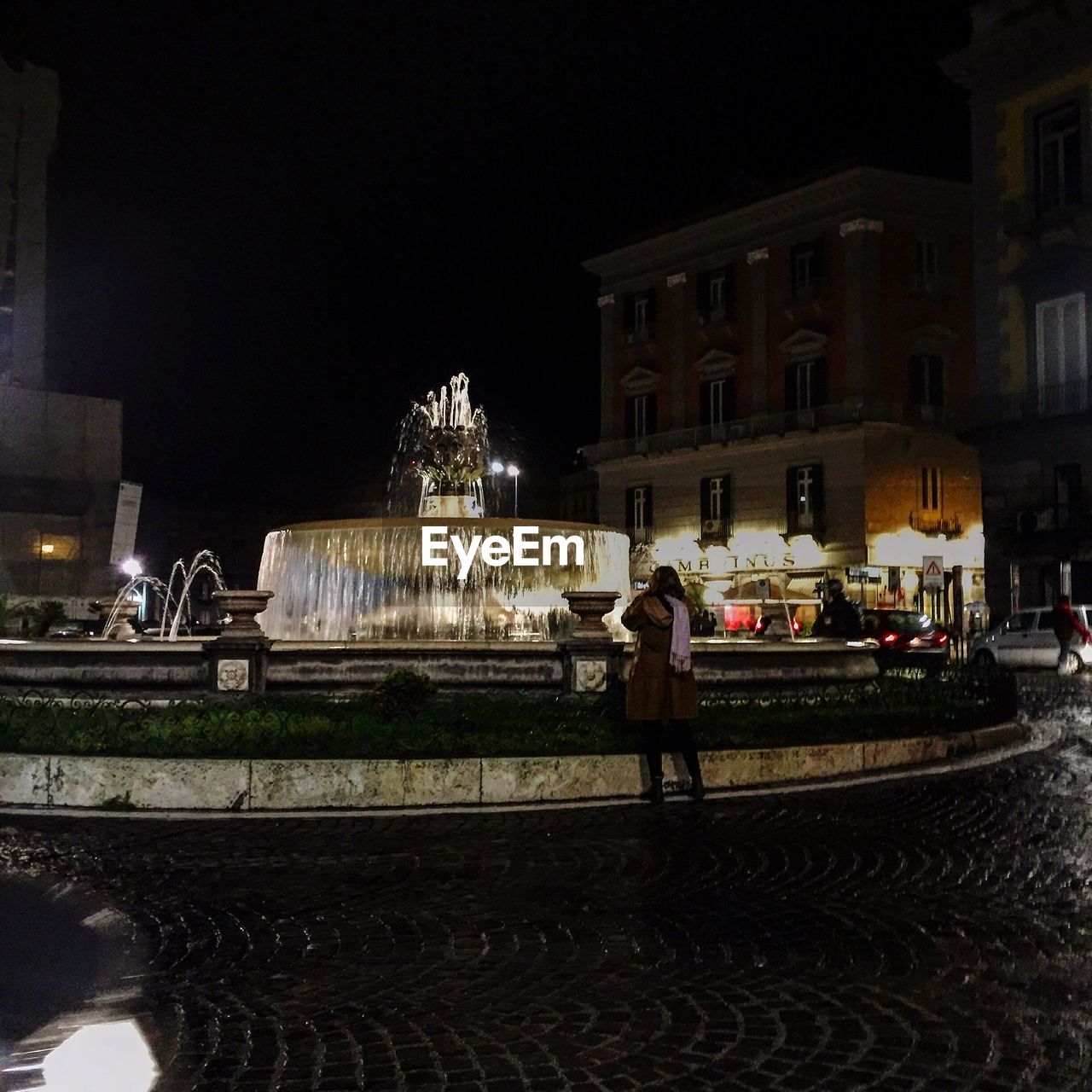 PEOPLE IN ILLUMINATED CITY AT NIGHT