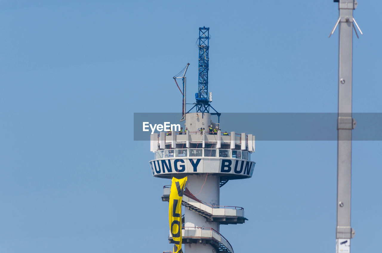 LOW ANGLE VIEW OF COMMUNICATIONS TOWER AGAINST SKY