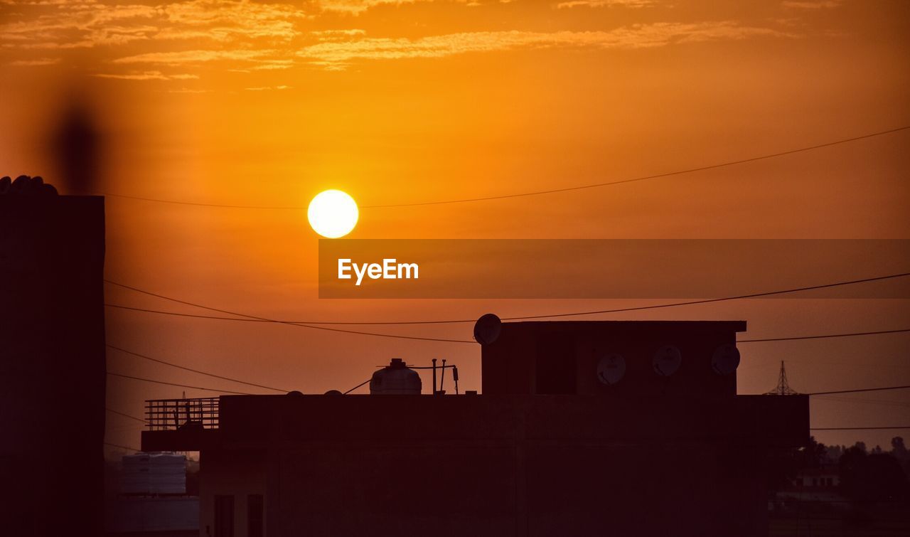 BUILDINGS IN CITY AT SUNSET