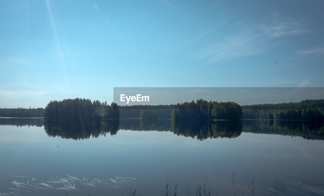 SCENIC VIEW OF LAKE BY TREES AGAINST SKY