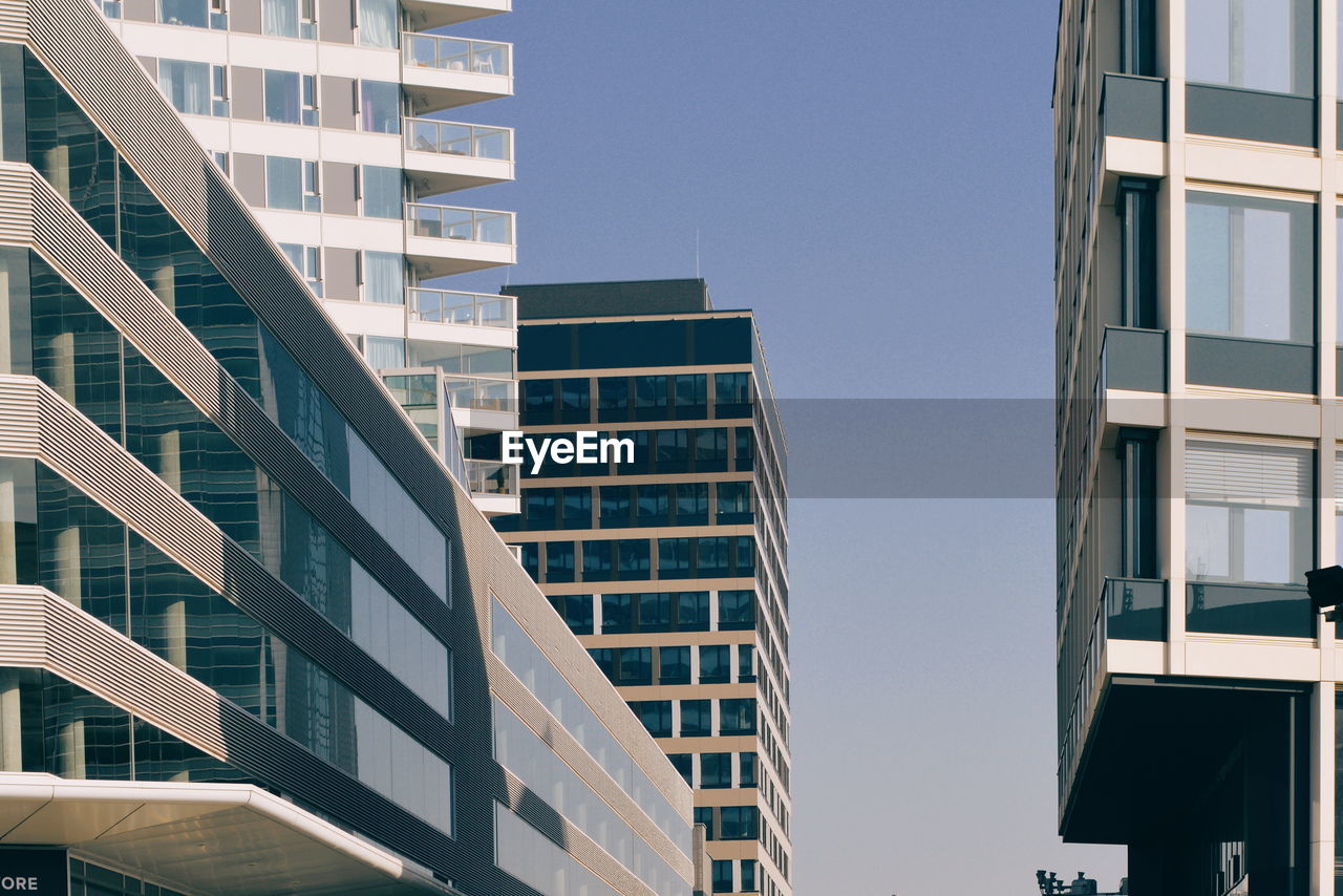 Low angle view of modern buildings against sky