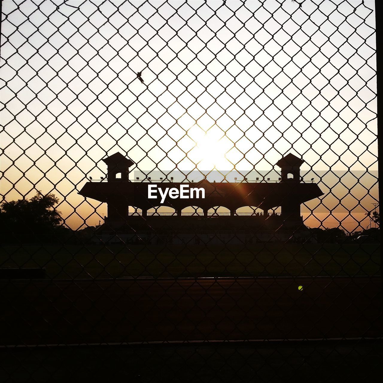 SILHOUETTE OF FENCE AT SUNSET