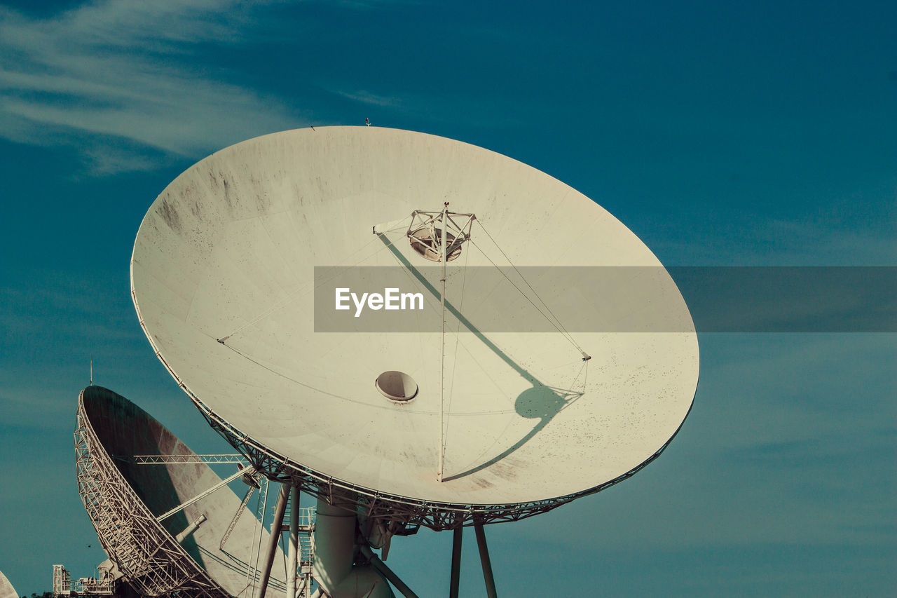 Low angle view of communications tower against sky