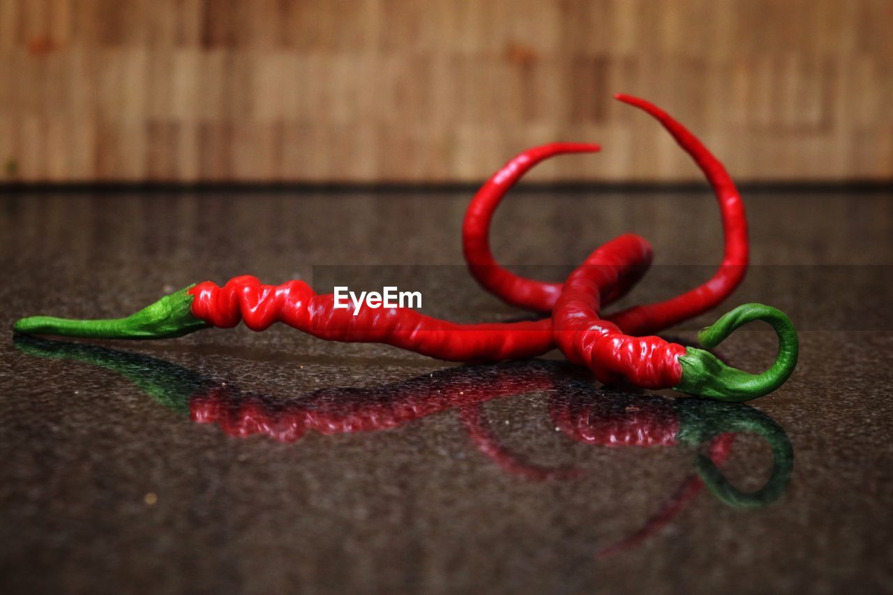 Close-up of red chili peppers on table