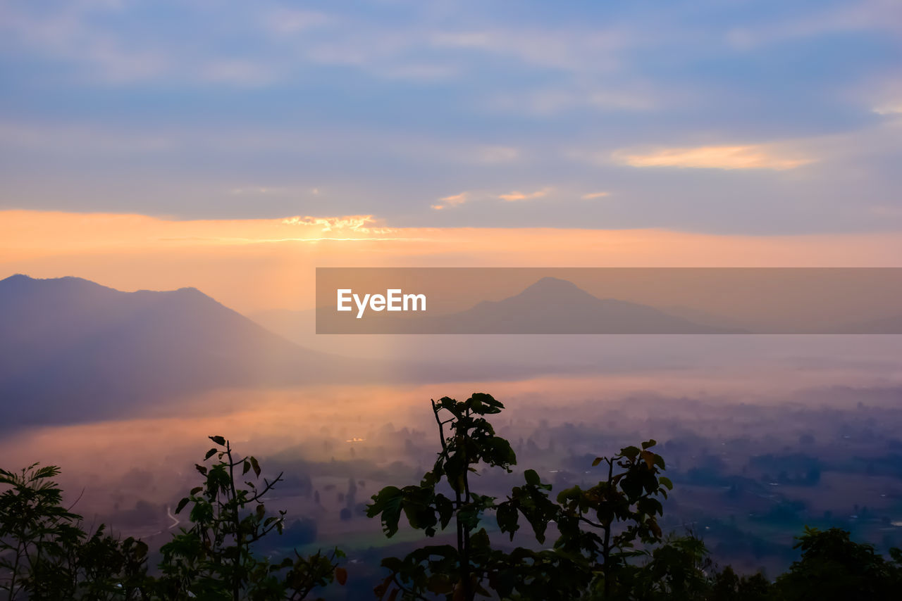 Scenic view of silhouette mountains against sky at sunset