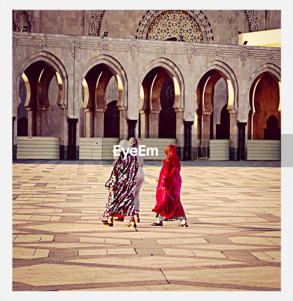 Women walking in courtyard of mosque