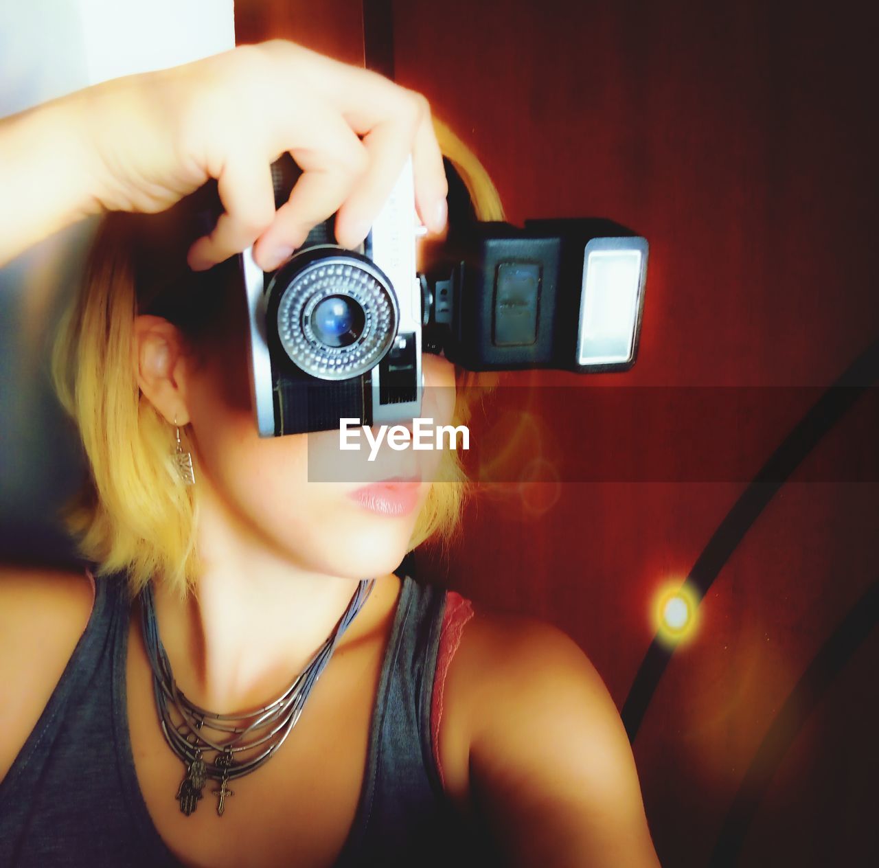 Close-up of woman photographing with camera