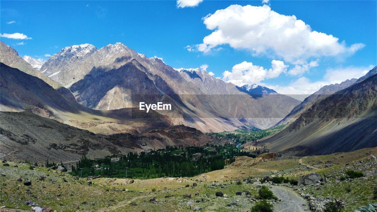 Scenic view of landscape and mountains against sky