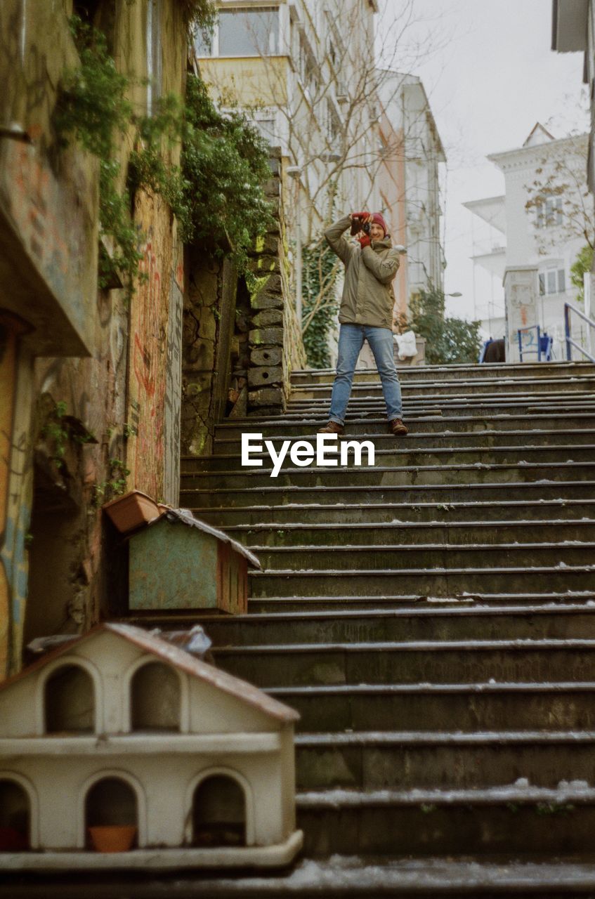 Young man taking pictures on the stairs