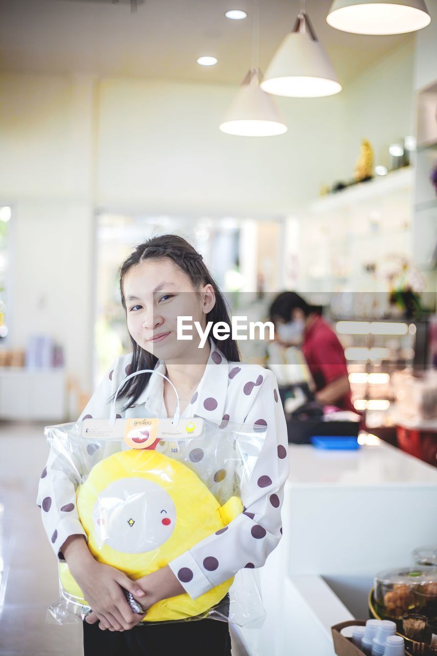 Portrait of teenager girl at store