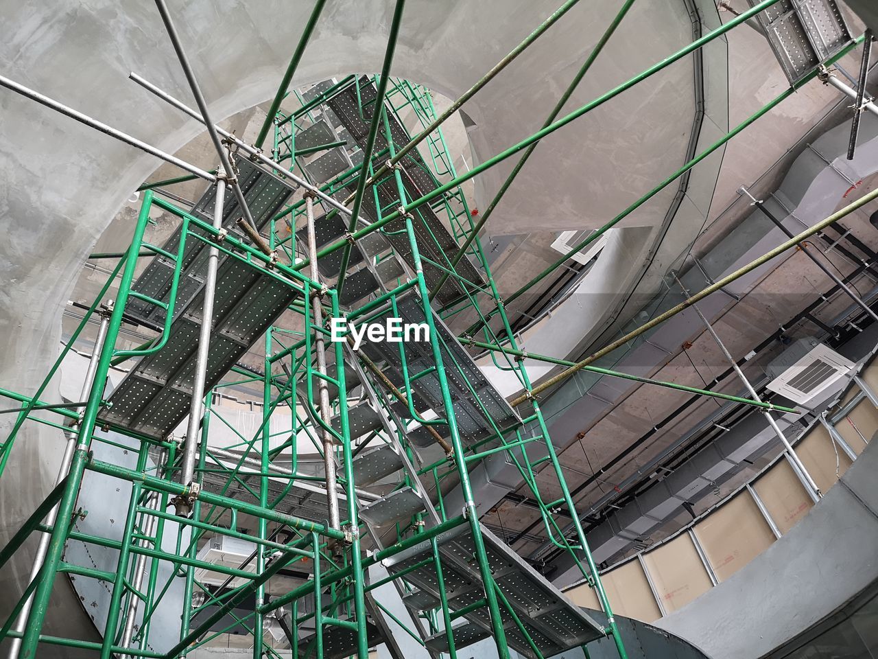 LOW ANGLE VIEW OF METAL STAIRCASE IN BUILDING