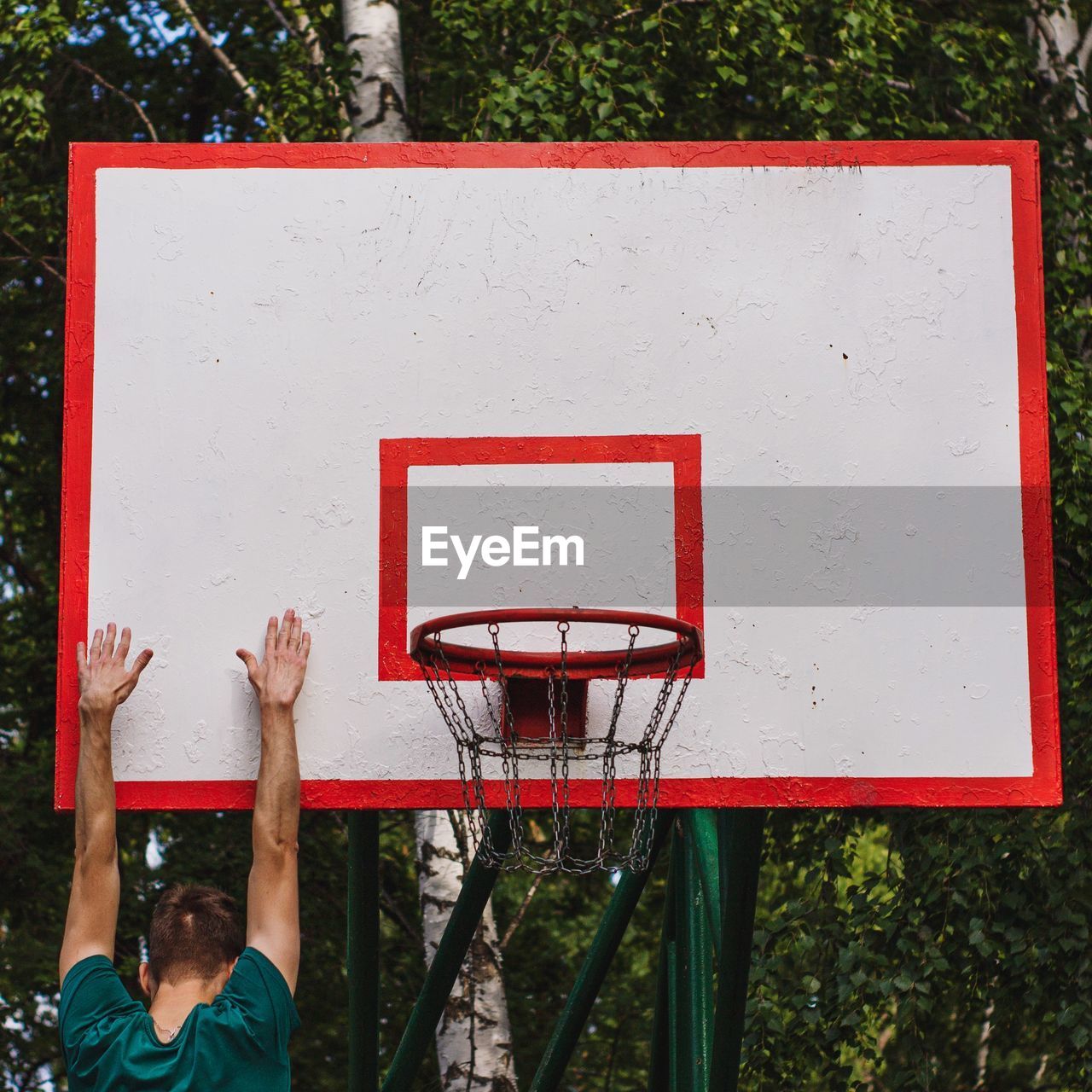 Low angle view of basketball hoop against red wall