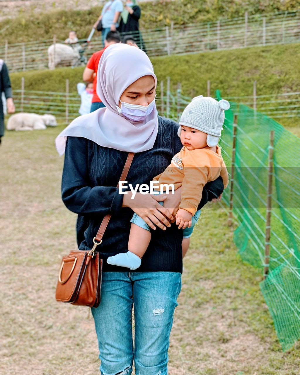 Mother with baby standing outdoors