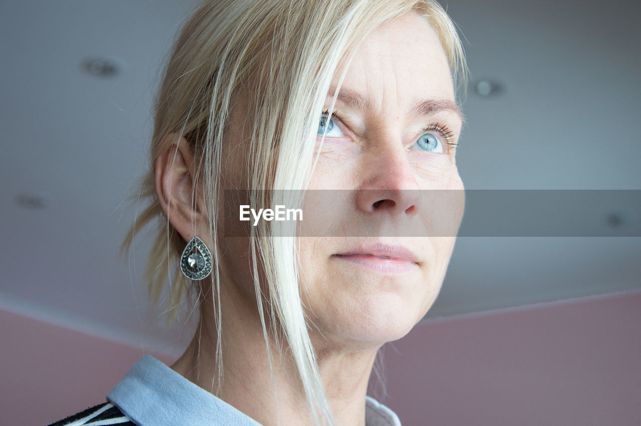 Mature woman looking away at home