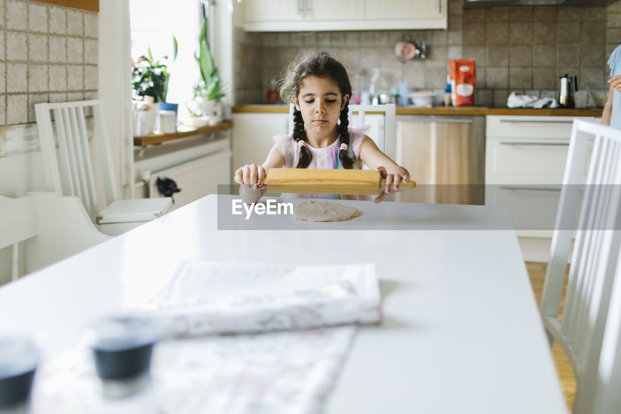 Girl rolling dough