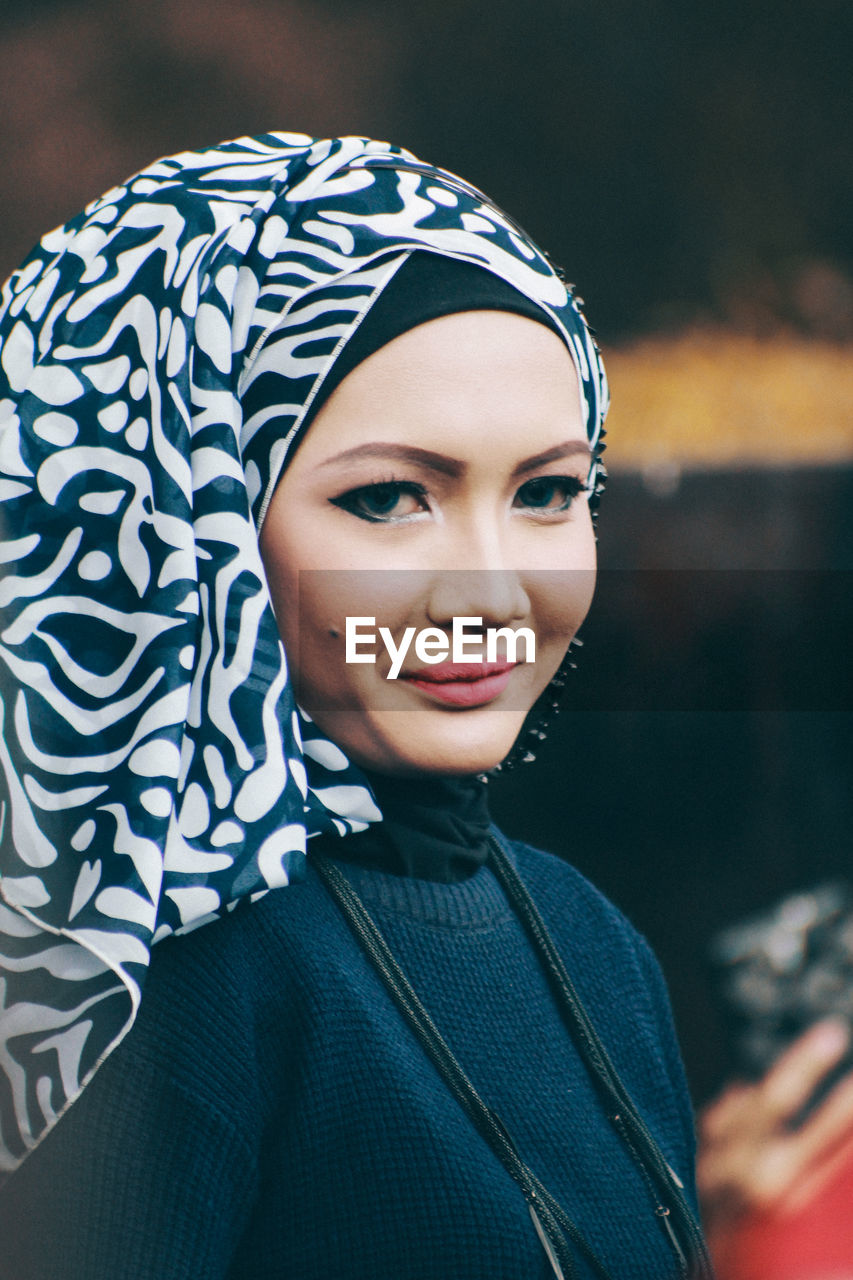 Close-up portrait of smiling young woman wearing hijab