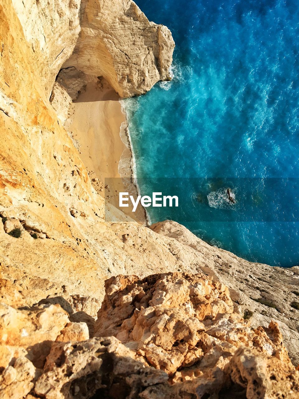 HIGH ANGLE VIEW OF ROCK FORMATION AT BEACH